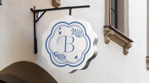 Closeup of a white storefront sign with blue logo