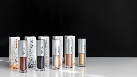 Closeup of five liquid eye shadow containers, next to their box packaging