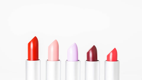 Closeup of five, open lipsticks of different heights