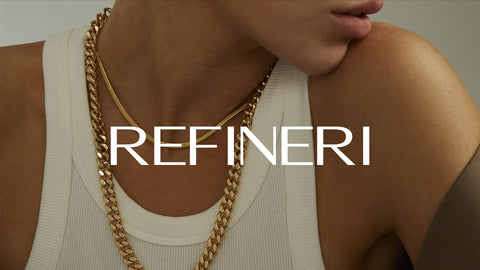 Woman wearing gold necklaces and white tanktop